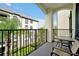 Relaxing balcony with seating and a view of the surrounding building and lush greenery at 4114 Breakview Dr # 30702, Orlando, FL 32819