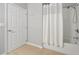 Clean bathroom features a shower and tub combination with a shower curtain and white door at 4114 Breakview Dr # 30702, Orlando, FL 32819