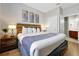Well-lit bedroom featuring a king bed with soft lighting and views to the ensuite bathroom at 4114 Breakview Dr # 30702, Orlando, FL 32819
