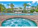 A luxurious resort-style pool with cabanas, lounge chairs, umbrellas, and a hot tub at 4114 Breakview Dr # 30702, Orlando, FL 32819