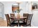 Cozy dining area features a dark wood table with four chairs, with kitchen view and modern light fixture at 4114 Breakview Dr # 30702, Orlando, FL 32819