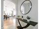 Inviting entryway with a decorative table, modern mirror, and open view into the living spaces at 4114 Breakview Dr # 30702, Orlando, FL 32819