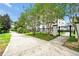 Exterior of a white condominium building behind a black gated entrance and lush green landscape at 4114 Breakview Dr # 30702, Orlando, FL 32819