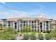 Beautiful condominium building with a tile roof, manicured landscaping, and ample parking at 4114 Breakview Dr # 30702, Orlando, FL 32819