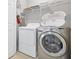 The laundry room offers modern washer and dryer units, plus overhead shelving at 4114 Breakview Dr # 30702, Orlando, FL 32819
