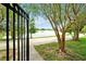 Picturesque view of a serene lake through a black metal gate and lush green trees at 4114 Breakview Dr # 30702, Orlando, FL 32819