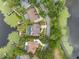 Stunning aerial view of a lakeside home with a private pool, lush landscaping, and dock access at 4536 N Landmark Dr, Orlando, FL 32817