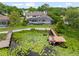 Aerial view of the home featuring a pool, dock, boat and scenic lake at 4536 N Landmark Dr, Orlando, FL 32817