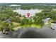 Breathtaking aerial view of a lakefront property surrounded by lush greenery, showcasing its serene setting and prime location at 4536 N Landmark Dr, Orlando, FL 32817
