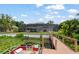 Backyard view of the screened-in pool, dock, and serene lake setting at 4536 N Landmark Dr, Orlando, FL 32817