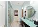 Modern bathroom with a stylish vanity, a glass shower, and bright lighting at 4536 N Landmark Dr, Orlando, FL 32817