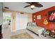 Cozy bedroom with a single bed, carpeted floors, and unique musical decor at 4536 N Landmark Dr, Orlando, FL 32817
