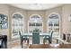 Charming breakfast nook surrounded by bright windows offering views of the backyard, perfect for casual dining at 4536 N Landmark Dr, Orlando, FL 32817