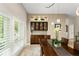 Dining room with custom cabinetry, pendant lights, shutters, and view to the front yard at 4536 N Landmark Dr, Orlando, FL 32817