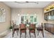 Dining room with elegant pendant lighting, shutters, and dining table for six guests at 4536 N Landmark Dr, Orlando, FL 32817