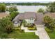 Beautiful home featuring lush landscaping, a well-manicured lawn, and mature palm trees in a lakeside community at 4536 N Landmark Dr, Orlando, FL 32817