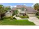 Stunning two-story home featuring a well-manicured lawn, mature landscaping, and a charming front entrance, offering great curb appeal at 4536 N Landmark Dr, Orlando, FL 32817