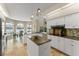 Modern kitchen with white cabinetry, granite countertops, stainless steel appliances, and breakfast nook, perfect for culinary enthusiasts at 4536 N Landmark Dr, Orlando, FL 32817
