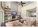 Cozy living room featuring a unique fireplace, high ceilings, dark floors, and a large comfortable couch at 4536 N Landmark Dr, Orlando, FL 32817