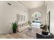 Elegant living room featuring high ceilings, large windows with backyard views, and stylish decor, creating a sophisticated ambiance at 4536 N Landmark Dr, Orlando, FL 32817