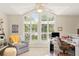 Bright living room featuring large windows, a cozy chair, and a functional workspace at 4536 N Landmark Dr, Orlando, FL 32817