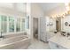 Main bathroom with walk-in shower, soaking tub, natural light, and double vanity at 4536 N Landmark Dr, Orlando, FL 32817