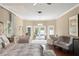Bright main bedroom with lounge area, hardwood floors, french doors, and views of the pool at 4536 N Landmark Dr, Orlando, FL 32817