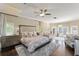 Spacious main bedroom with sitting area, french doors, hardwood floors and a ceiling fan at 4536 N Landmark Dr, Orlando, FL 32817