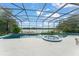 Spacious screened-in pool area with a spa overlooking a serene lake at 4536 N Landmark Dr, Orlando, FL 32817