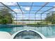 Inviting screened-in pool and spa with tranquil lake views at 4536 N Landmark Dr, Orlando, FL 32817