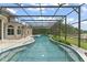 Expansive screened-in pool area with spa and beautiful lake views at 4536 N Landmark Dr, Orlando, FL 32817