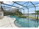 Gorgeous screened-in pool with spa, lush landscaping, and lake views, perfect for outdoor entertaining and relaxation at 4536 N Landmark Dr, Orlando, FL 32817