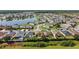 Expansive aerial view showcases a Primary-planned community with a lake and well-maintained properties at 4553 Baler Trails Dr, St Cloud, FL 34772