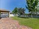 Backyard with covered patio, green grass, playset, and fenced yard at 4553 Baler Trails Dr, St Cloud, FL 34772