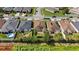 Aerial view showcases backyards with patios, pools and green spaces bordered by a fence and lush foliage at 4553 Baler Trails Dr, St Cloud, FL 34772