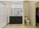 Bright bathroom with double vanity, walk-in shower with glass door, and closet at 4553 Baler Trails Dr, St Cloud, FL 34772