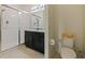 Bathroom featuring a double vanity, walk-in shower with glass door, and toilet at 4553 Baler Trails Dr, St Cloud, FL 34772
