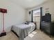 Cozy bedroom with neutral walls, carpet, a dresser, and a full bed with decorative pillows at 4553 Baler Trails Dr, St Cloud, FL 34772