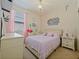 Bright bedroom with a chandelier, light pink drapes, and pastel decor at 4553 Baler Trails Dr, St Cloud, FL 34772