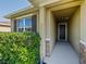 Inviting entryway featuring stone accents and a covered porch, creating a warm welcome to the home at 4553 Baler Trails Dr, St Cloud, FL 34772