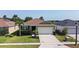 Lovely single-story home with an attached two-car garage, complimented by green lawn and landscaping at 4553 Baler Trails Dr, St Cloud, FL 34772