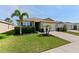 Inviting home featuring lush landscaping, a green lawn, and a convenient two-car garage at 4553 Baler Trails Dr, St Cloud, FL 34772