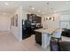 Modern kitchen features dark cabinets, granite counters, stainless steel sink, and pendant lighting at 4553 Baler Trails Dr, St Cloud, FL 34772