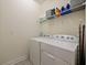 Functional laundry area with washer, dryer, and storage shelf at 4553 Baler Trails Dr, St Cloud, FL 34772