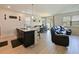 Open living and dining space features kitchen with breakfast bar and cozy living room at 4553 Baler Trails Dr, St Cloud, FL 34772