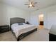 Bright main bedroom with carpet flooring, ceiling fan, and en-suite bathroom access at 4553 Baler Trails Dr, St Cloud, FL 34772