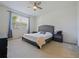 Bright main bedroom features carpet flooring, ceiling fan, and a large window at 4553 Baler Trails Dr, St Cloud, FL 34772