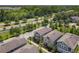 Modern residential architecture showcases uniform rooflines, neutral color palettes, sidewalks and manicured lawns surrounded by mature trees at 4630 Socrates Way, Sanford, FL 32773