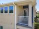 A covered balcony featuring a white railing, offering a view of the street and surrounding landscape at 4630 Socrates Way, Sanford, FL 32773