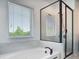 Contemporary bathroom showcasing a soaking tub and glass-enclosed shower with neutral tiling at 4630 Socrates Way, Sanford, FL 32773